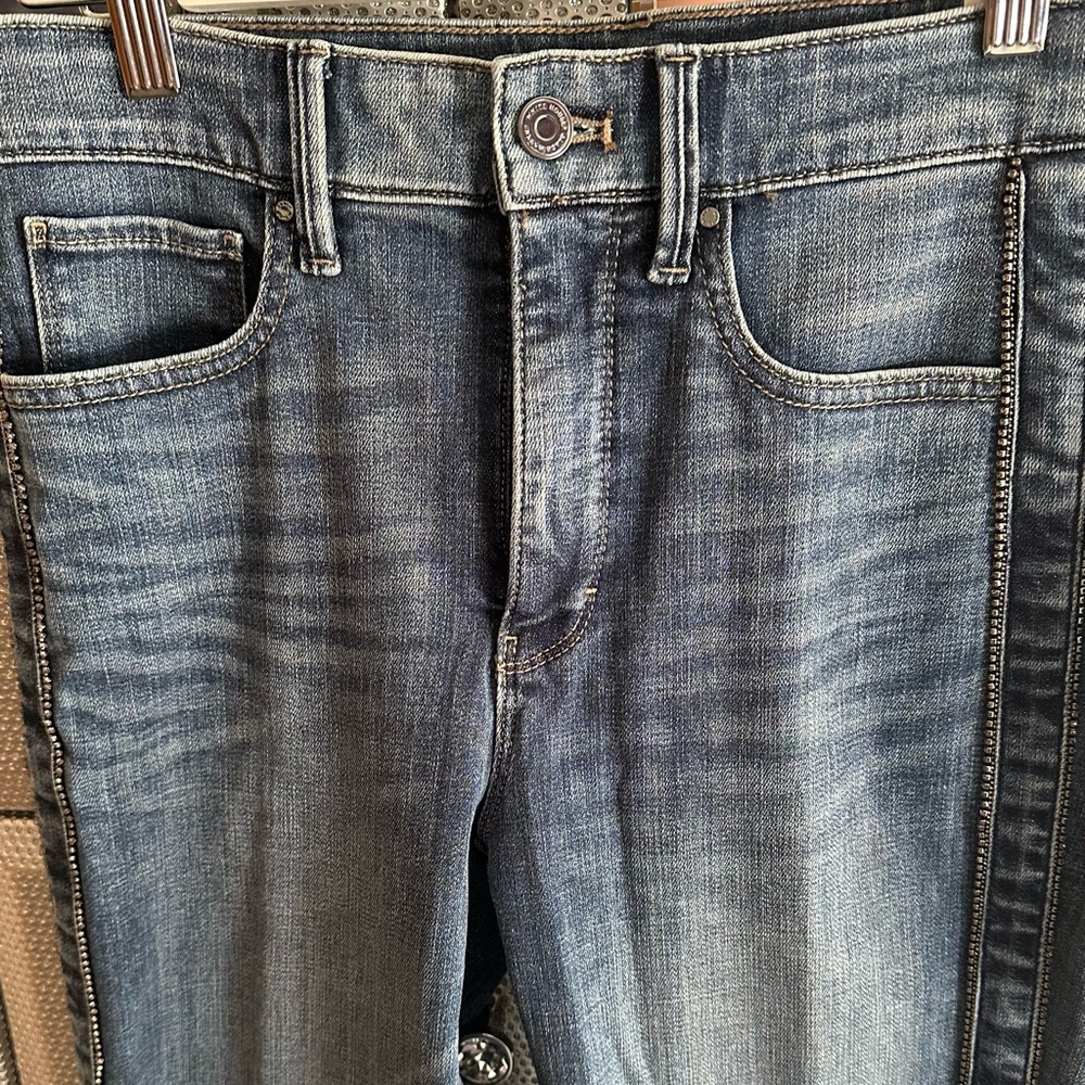 Embellished jeans by embellishment is down the side of each leg.